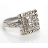 CERTIFICATED DIAMOND RING the central princess cut diamond measuring 1.