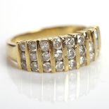 DIAMOND DRESS RING with rows of channel set brilliant cut diamonds totalling approximately 0.