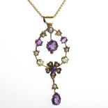 EARLY TWENTIETH CENTURY AMETHYST AND PERIDOT PENDANT of oval floral design,