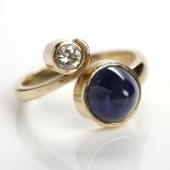 SAPPHIRE AND DIAMOND RING the split bezel with terminals set with a single conical cabochon cut