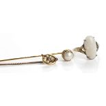 TWO EARLY TWENTIETH CENTURY PEARL SET GOLD STICK PINS together with a nine carat gold opal set