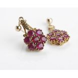 ATTRACTIVE RUBY DROP EARRINGS each set with seven round rubies of 3mm diameter in a daisy motif