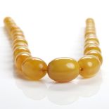 GRADUATED AMBER BEAD NECKLACE formed by ovoid beads, the largest bead 30mm wide,