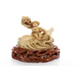 EARLY 20TH CENTURY CHINESE IVORY CARVING of a figure atop a swimming water buffalo, 11.