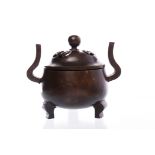 EARLY 20TH CENTURY CHINESE BRONZE CENSER with pierced lid and on tripod feet,