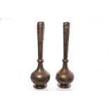 PAIR OF 19TH CENTURY ISLAMIC BRASS BURNERS with long slender necks and globular bodies,