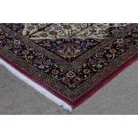 TWO 20TH CENTURY PERSIAN FRINGED AND BORDERED SILK RUGS both decorated with stylised floral and