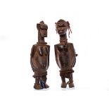 TWO BURKINA FASO CARVED HARDWOOD FIGURES modelled as standing male and female,