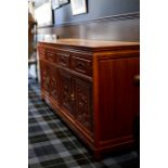 MID 20TH CENTURY CHINESE ROSEWOOD SIDEBOARD with two cupboards and four drawers, 181cm long,