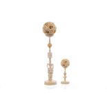 TWO EARLY 20TH CENTURY CHINESE IVORY CONCENTRIC BALLS ON STANDS the larger example with stand