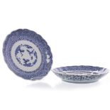 PAIR OF EARLY 20TH CENTURY BLUE AND WHITE PLATES decorated to the interior with a trees,