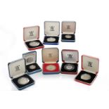 GROUP OF SILVER PROOF COINS comprising a D-Day 50 pence coin, two £5 coins,