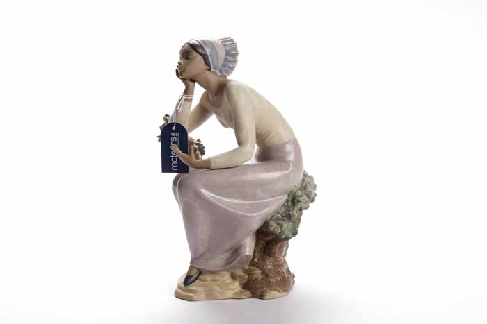 LARGE LLADRO BISQUE FIGURE modelled as a girl resting on a tree branch over a naturalistic base,