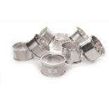 SET OF SIX SILVER NAPKIN RINGS with engine turned decoration each bearing a different initial,