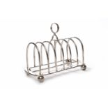 FOUR DIVISION ARCHED SILVER TOAST RACK with loop handle, maker T.