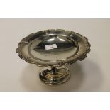 GEORGE V CIRCULAR SILVER COMPORT with moulded scroll and husk border,