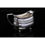 GEORGE III OBLONG SILVER MILK JUG decorated with a ribbed band within a gadrooned border,