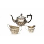 THREE PIECE SILVER OVAL AFTERNOON TEA SERVICE with a wide band of embossed scrolls,