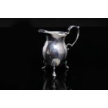 GEORGE III SILVER BALUSTER CREAM JUG with scroll handle on three paw feet, maker WH, London 1812,