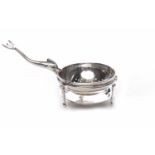 GEORGE V SILVER TEA STRAINER ON STAND the handled modelled as a mythical fish, by Brook & Son,