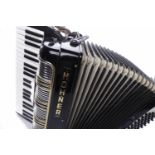 HOHNER 21L PIANO ACCORDION with black finish, with strap and sheet music in original case,