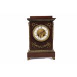LATE VICTORIAN MAHOGANY MANTEL CLOCK with enamel Roman numeral chapter ring encircling a machined