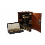 EARLY TO MID-20TH CENTURY BRASS MICROSCOPE in mahogany case; including one brass slide,
