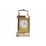 BRASS CARRIAGE CLOCK BY HENLEY of serpentine outline,