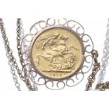 GOLD SOVEREIGN DATED 1915 in an unmarked pendant mount, on a chain with indistinct marks,