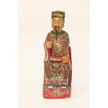 MID 20TH CENTURY CHINESE PAINTED WOOD TEMPLE GUARDIAN modelled as a seated man, with beard,