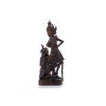 EARLY 20TH CENTURY INTRICATELY BALINESE CARVED WOOD GROUP depicting a standing goddess and