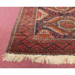 EARLY 20TH CENTURY BOKHARA RUG with geometric designs in red, black, orange, brown and white,