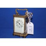 LATE 19TH CENTURY BRASS CARRIAGE CLOCK the enamelled Arabic numeral dial with hairline cracks and