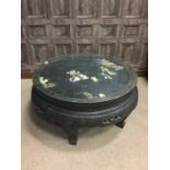 MID 20TH CENTURY CHINESE CIRCULAR TABLE with figures in relief to the top, with glass top,