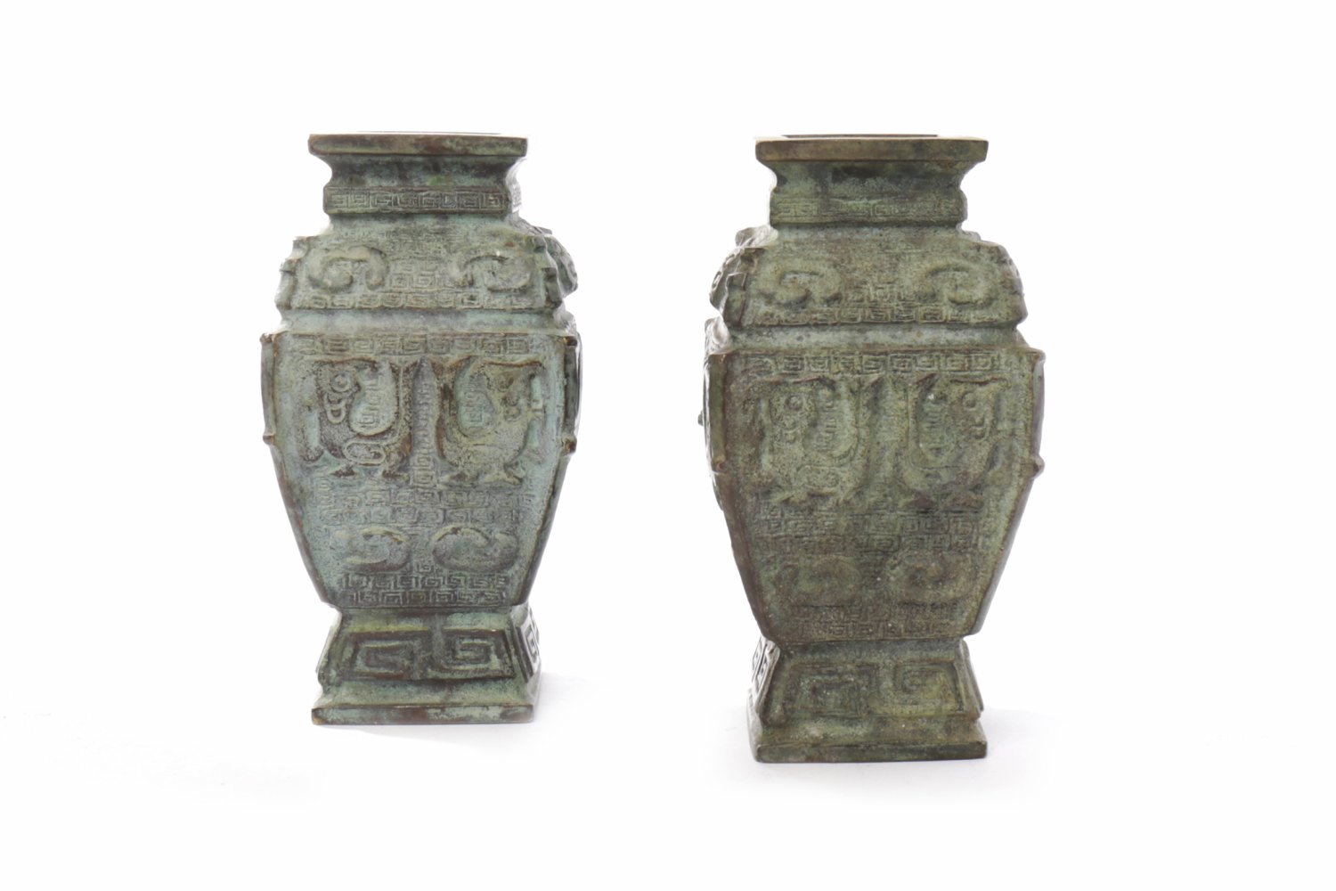 PAIR OF 20TH CENTURY CHINESE BRONZE VESSELS in an archaic style, with tao tie motifs in relief,
