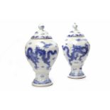 PAIR OF MID 20TH CENTURY CHINESE BLUE AND WHITE LIDDED VASES with dragon decoration,