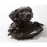 A BRONZE INK STAND, 
in the form of a hounds head with a hinged top, 4in (10cm).