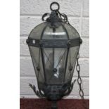 A BRONZED METAL HALL LANTERN, of hexagonal tapering form, with twelve glass panels and domed top,