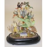 TAXIDERMY:  A GROUP OF STUFFED AND MOUNTED EXOTIC BIRDS, 
under a glass dome, on oval ebonized base,