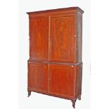 A GEORGE IV PERIOD EBONY STRUNG MAHOGANY GENTLEMAN'S WARDROBE, the moulded cornice,