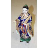 A LATE 19TH CENTURY JAPANESE PORCELAIN FIGURE, modelled as a man with moustache,