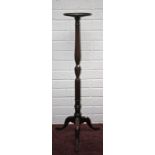 A MAHOGANY TORCHÈRE, with three stage reeded stem, supporting a circular dish top on tri-pod base,