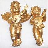 A PAIR OF CARVED GILTWOOD WALL APPLIQUES, 
each modelled as a musical cherub, 18.5in (47cm).