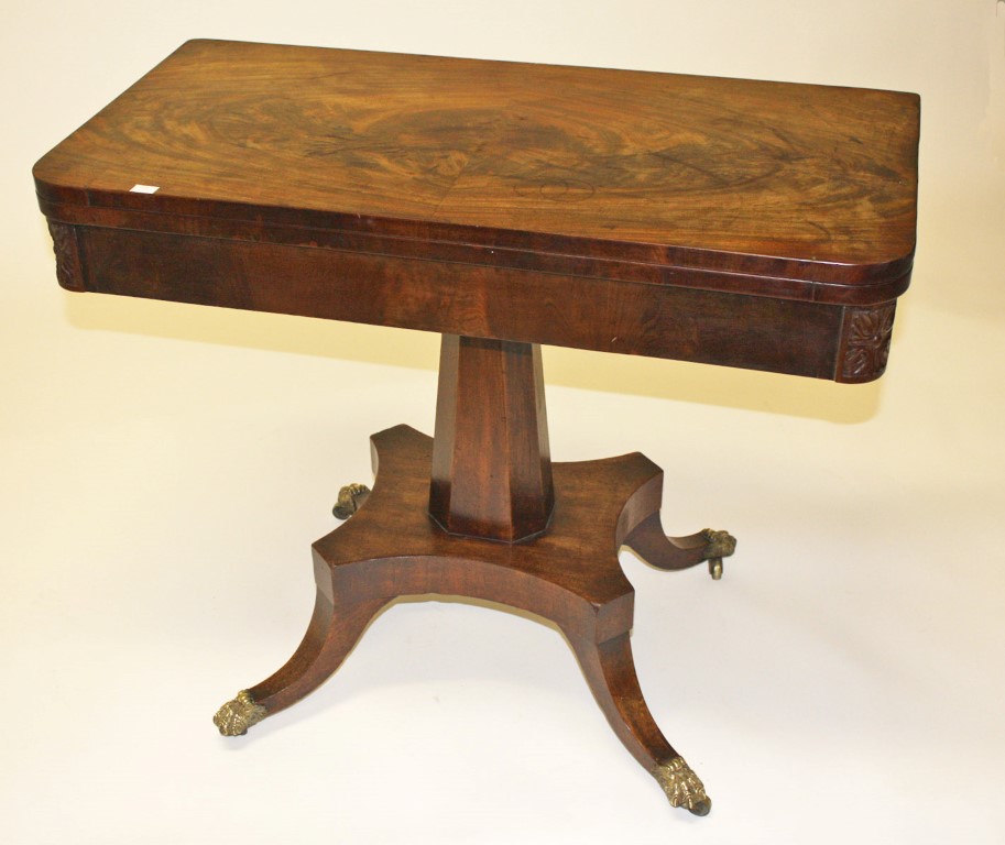 A LATE REGENCY PERIOD MAHOGANY FOLD OVER CARD TABLE, the top with rounded corners,