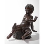 A BRONZE FIGURE, 
modelled as a startled cherub, nude, with frog on his right knee,