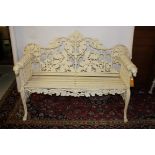 A HEAVY CAST IRON GARDEN BENCH, the back formed with scrolling oak leaves and acorns,