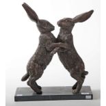 A LARGE BRONZE GROUP, 
modelled with two hares boxing, on an oblong grained black marble base,