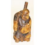 A CARVED CHINESE WOODEN FIGURE OF A STANDING  BUDDHA, 
wearing a bead necklace, 26in (66cm).