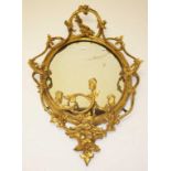 A PAIR OF 19TH CENTURY OVAL GILT AND GESSO GIRANDOLES, each crested with a scroll cartouche,