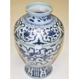 A CHINESE BLUE AND WHITE STONEWARE VASE, decorated with snarling temple lions amongst foliage,
